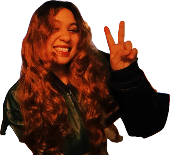 Denisse smiling and throwing up a peace sign